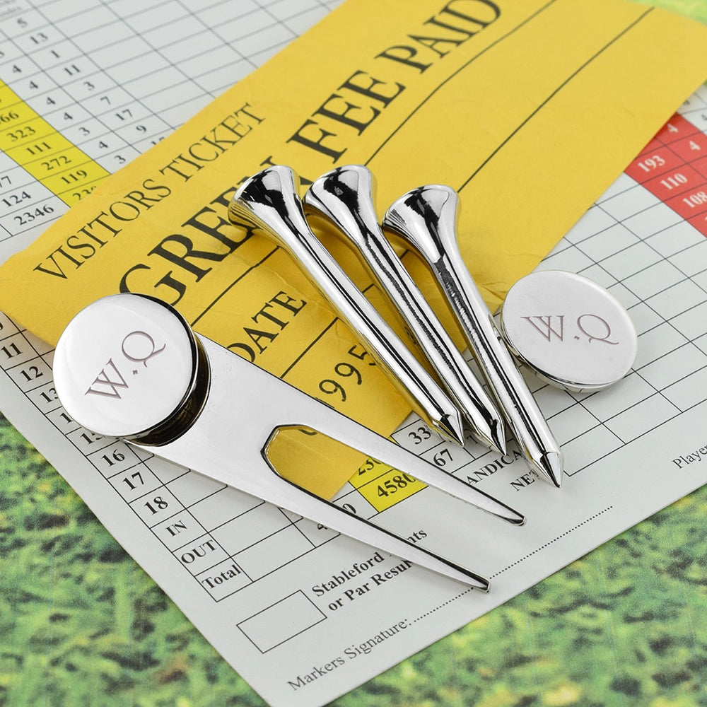 Image of a golf tee set which comprises of 3 silver plated golf tees, a divot repair tool and a ball marker. The divot tool and ball marker can both be engraved with initials of your choice.