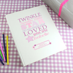 Personalised photo album with the text 'twinkle twinkle little star do you know how loved you are' printed on the front cover in various fonts and sizes in different shades of pink. The cover can be personalised with a name and message or celebration details of your choice. Internally the album has approximately 30 pages interleafed with tissue.